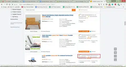 Alibaba product search results page with supplier listings and pricing for laptop tables.