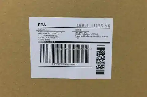 Printed Amazon FBA box label affixed to cardboard carton showing box number and warehouse address