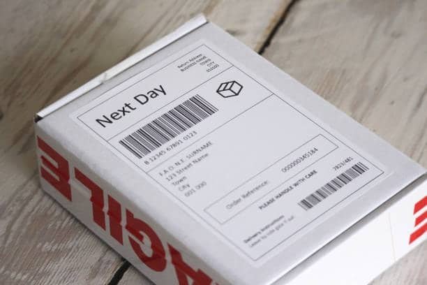 Next Day parcel box featuring a barcode shipping label similar to Amazon FBA box label standards