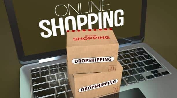 dropshipping boxes on laptop representing online drop shipper business