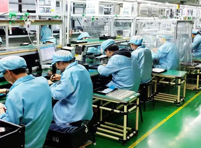 Workers on an electronics assembly line in a Chinese factory, highlighting the importance of verifying suppliers and their production processes