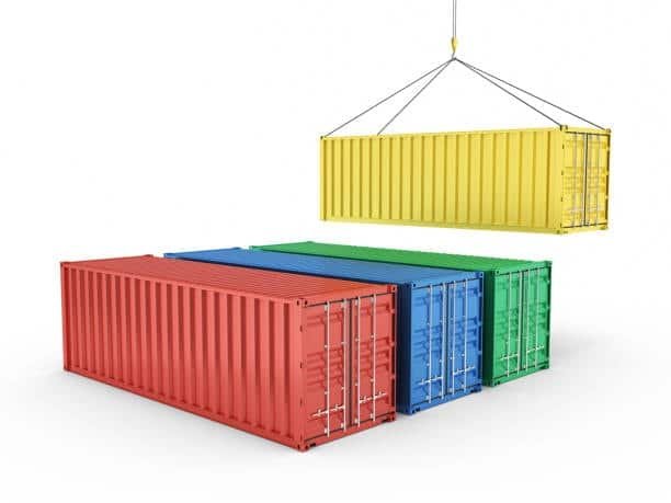 Yellow container lifted by crane above red, green, and blue containers, illustrating handling of LCL freight.