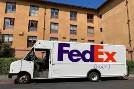 FedEx Ground delivery truck parked in residential area during home delivery service