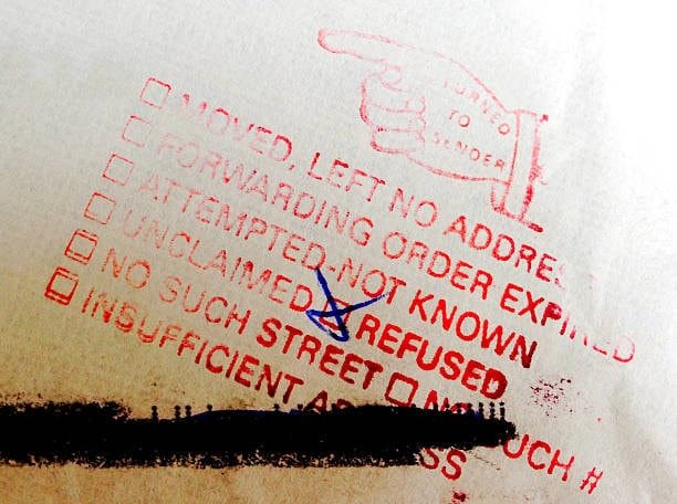 USPS undeliverable mail status slip with marked refused box.