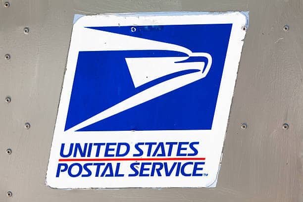 United States Postal Service logo on metal surface.