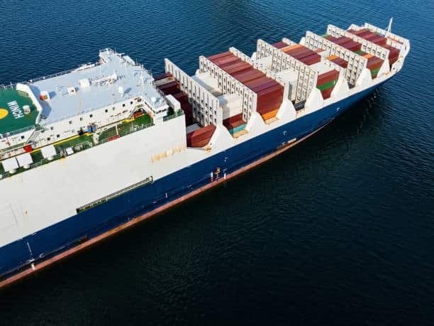 Large RoRo cargo vessel transporting vehicles, emphasizing automotive logistics and related drayage services.