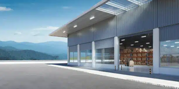 Modern warehouse facility with open loading area and storage inside.