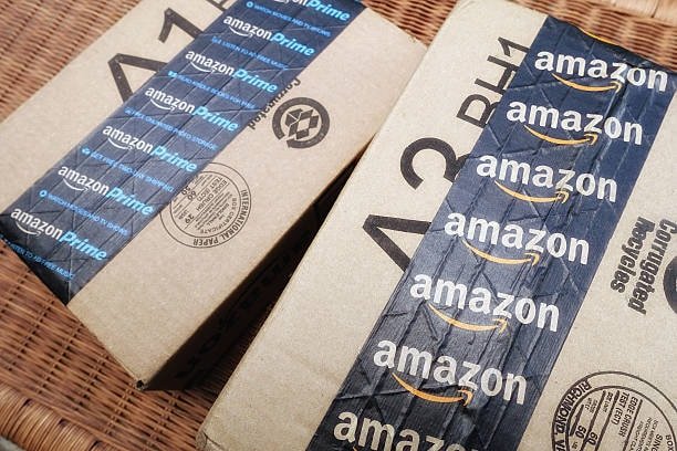Amazon boxes and mailers sorted on warehouse shelf showing correct packaging and labeling