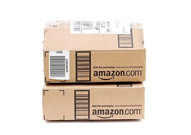 Stacked Amazon shipping cartons with barcode labels and proper packaging format