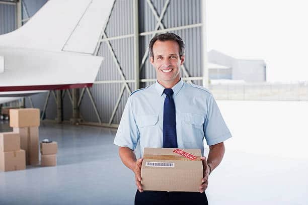 Delivery officer holding a parcel that has been cleared from customs