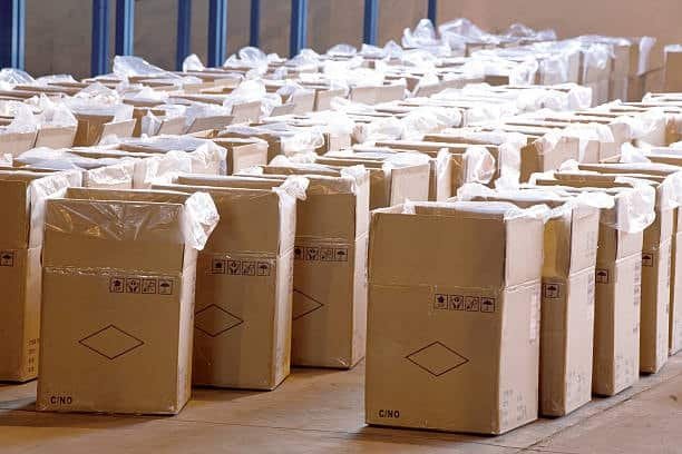 Large quantity of cartons arranged inside warehouse after being cleared from customs