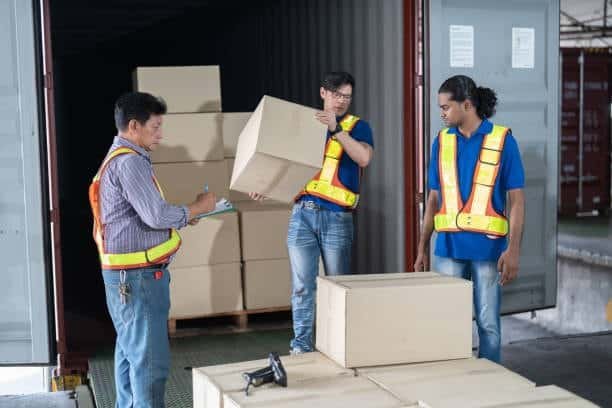 Workers checking cartons during customs inspection and verification process