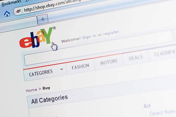 Close-up of the eBay homepage showing seller navigation and category options related to shipping settings.