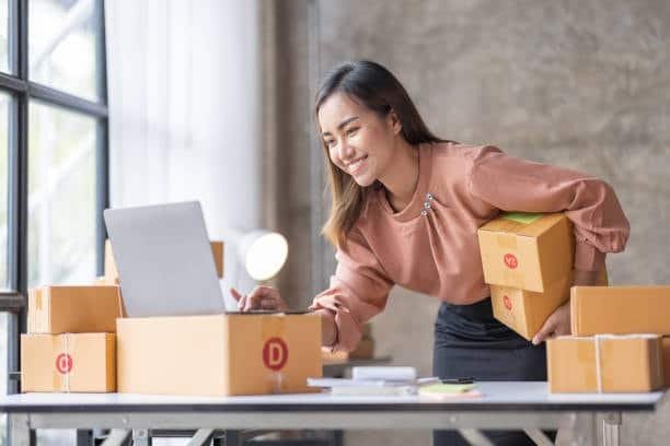A business owner packing boxes and preparing customs documentation for overseas shipments.