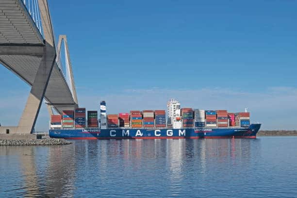 CMA CGM container ship transporting cargo through international economy shipping outside the US.