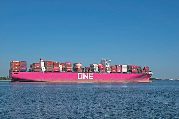 Large container vessel transporting goods through economy shipping outside the US.