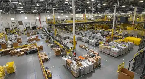 Fulfillment center with shelves, pallets, and logistics operations in process.