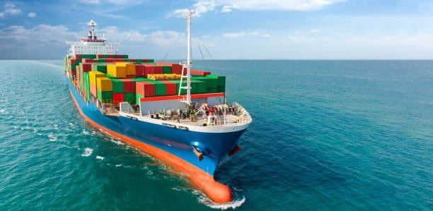 Large cargo vessel transporting containers across a major global shipping channel.