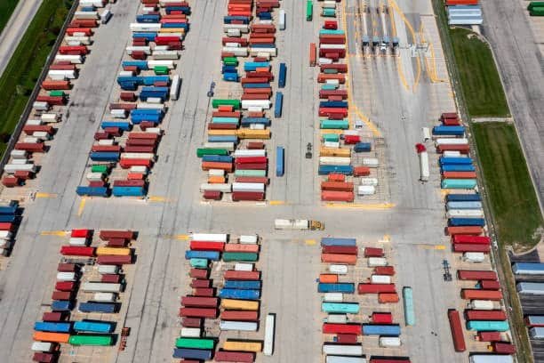 Aerial view of a large container yard preparing shipments for international economy shipping outside the US.