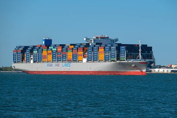 Wan Hai Lines container vessel transporting goods through international economy shipping outside the US.