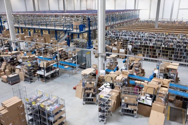 Large fulfillment center processing big box shipments, packaging, and storage operations.