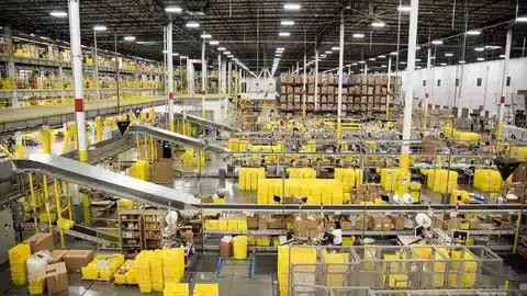 Fulfillment center employees managing and packaging customer orders.