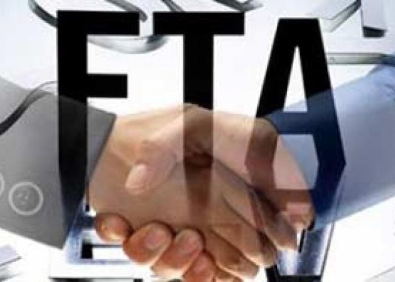 A handshake with "FTA" text overlay, symbolizing Free Trade Agreements that help importers reduce duties and boost global trade in 2025.