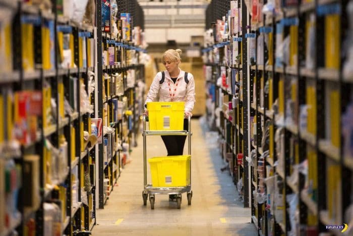 Employee picking apparel orders from warehouse shelves for FBA and DTC fulfillment.