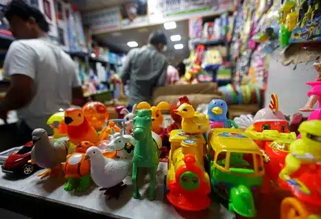 Imported toys displayed on retail shelves ready for sale in a toy shop.