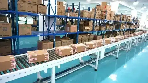 Parcels moving on an automated conveyor belt in a China warehouse, illustrating efficient sorting and fulfillment for dropshipping sellers.