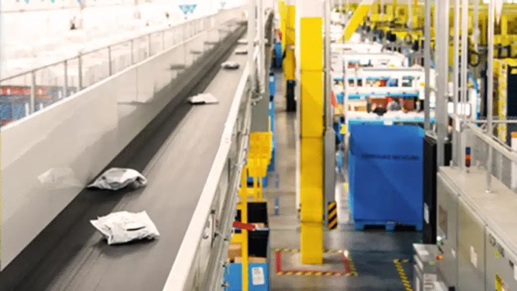 Conveyor belt moving parcels in a modern fulfillment center, representing automated processing for multichannel ecommerce operations.