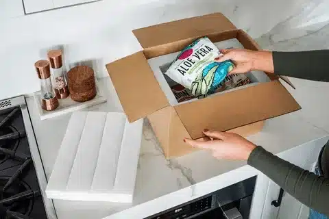 Ecommerce order fulfillment process with products packed into custom packaging boxes