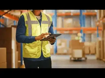 Inspector using a digital checklist on a tablet during Amazon FBA product inspection.