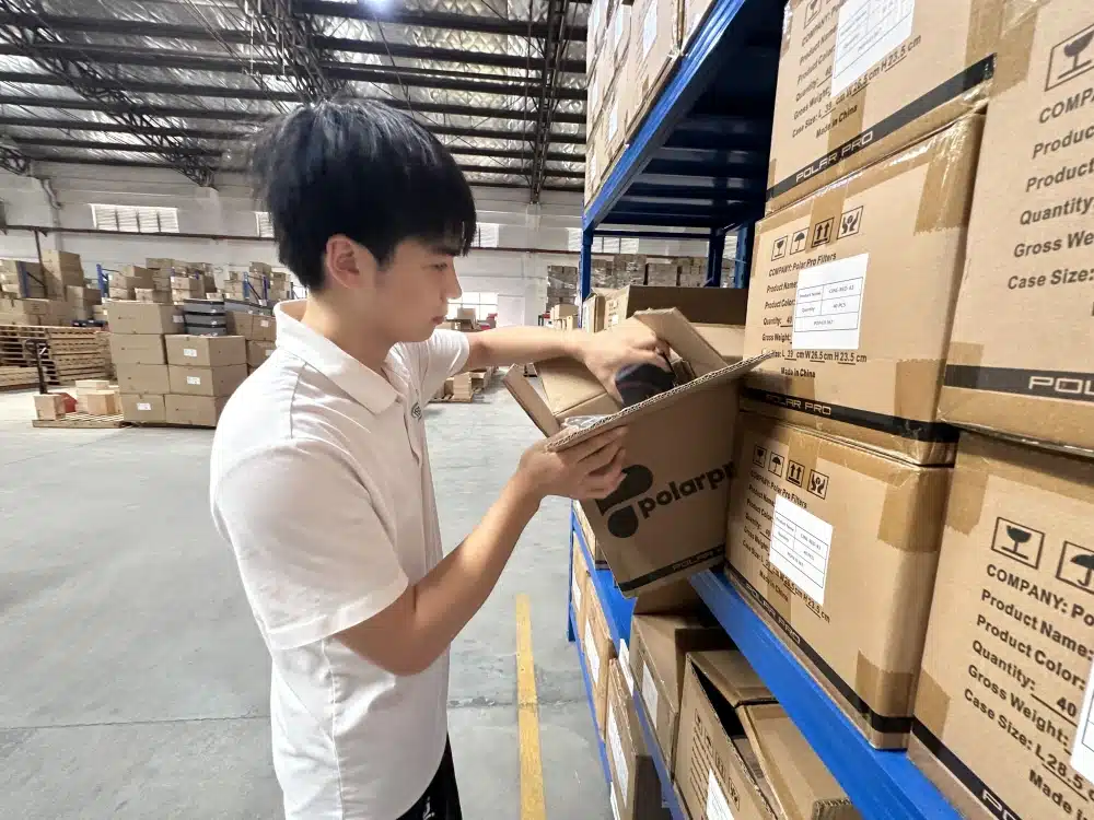 Warehouse worker picking an item from a shelf carton in a China 3PL fulfillment warehouse