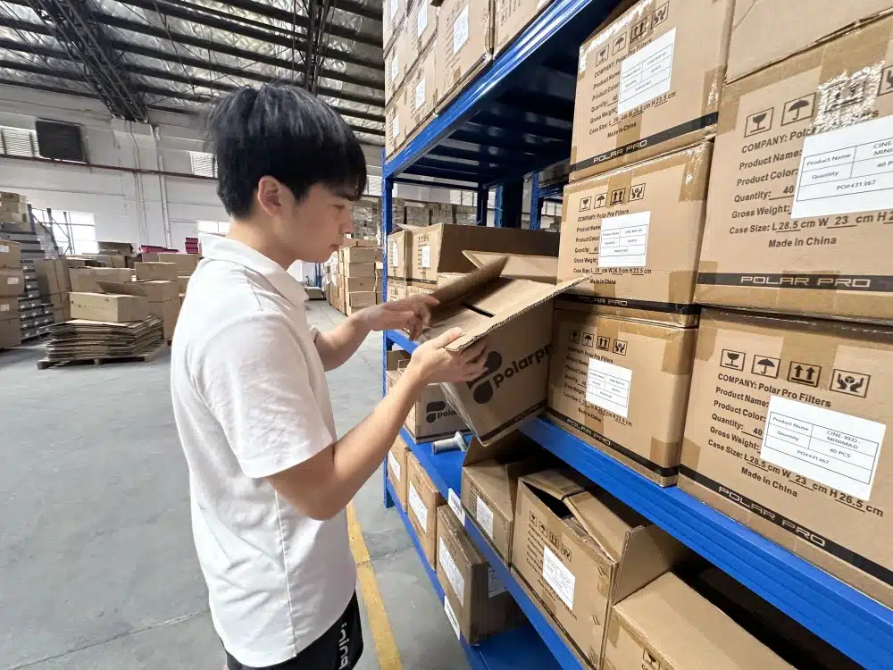 Warehouse worker inspecting cartons during inventory receiving for China-to-USA ecommerce fulfillment