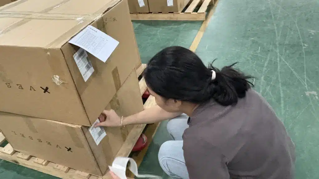 Warehouse staff verifying SKU labels on palletized cartons during a 3PL inventory audit to ensure inventory accuracy and traceability.