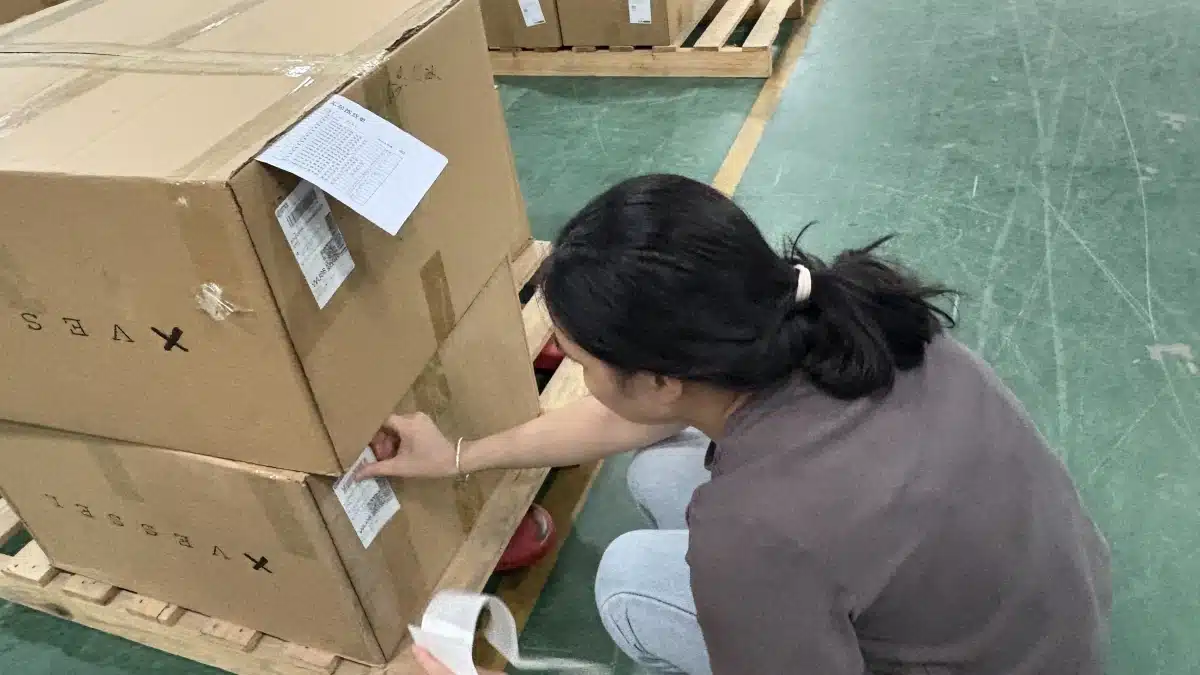 Warehouse staff verifying SKU labels on palletized cartons during a 3PL inventory audit to ensure inventory accuracy and traceability.