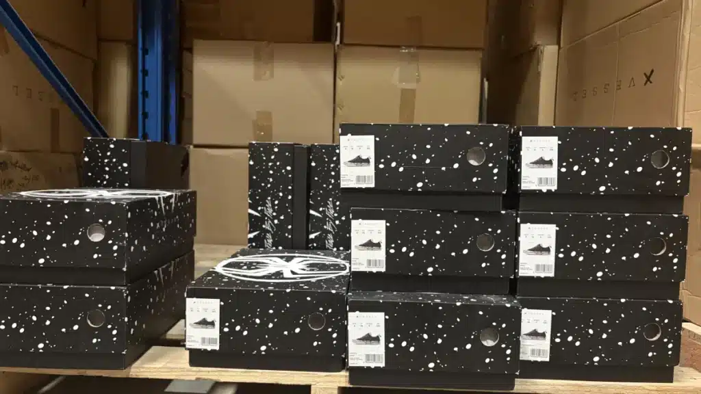 Bulk inventory of labeled product boxes stored in a warehouse, showing how ecommerce brands can move from print-on-demand to bulk inventory fulfillment with a 3PL.