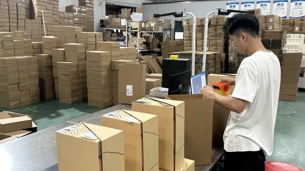 Warehouse worker packing bulk inventory orders at a China fulfillment center, supporting a dropship and bulk fulfillment hybrid model for growing ecommerce brands.