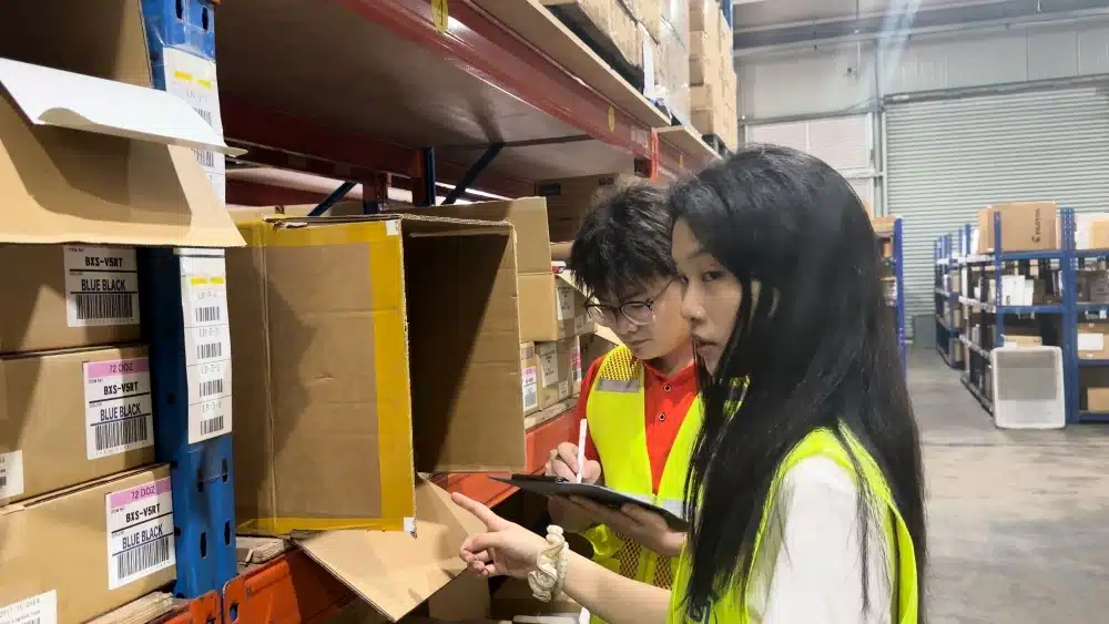 Warehouse team checking SKU labels and stock records for US-China trade fulfillment contingency planning