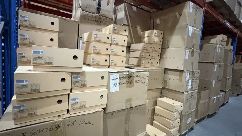 Warehouse worker checking SKU inventory in a China 3PL facility to manage stock allocation between Amazon FBA and other ecommerce sales channels.
