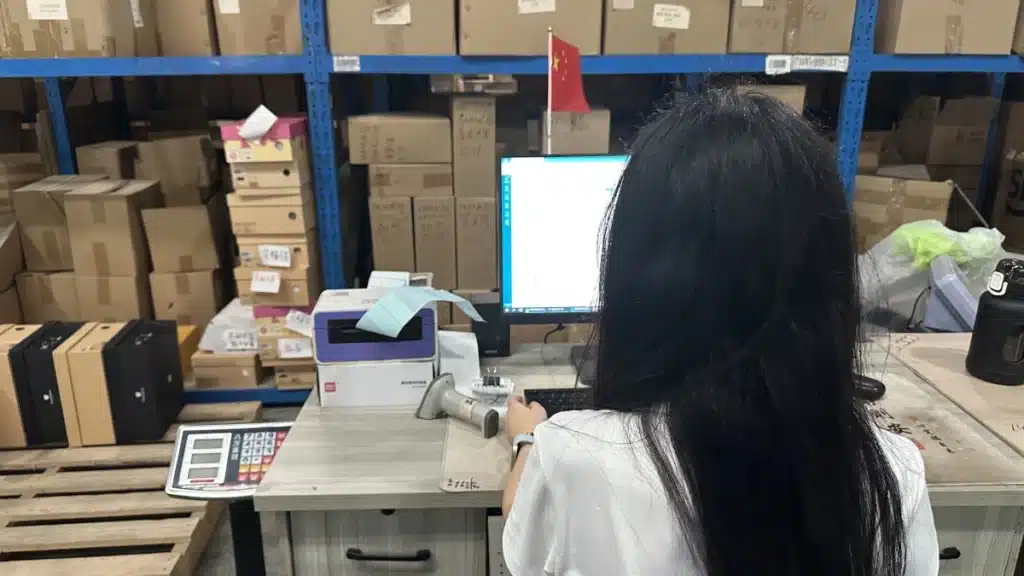 3PL warehouse staff managing ecommerce inventory through a WMS to support real-time stock control in a dropship and bulk fulfillment hybrid strategy.