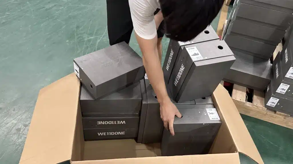 Warehouse worker preparing multiple ecommerce products for shipment to improve order accuracy, fulfillment performance, and long-term customer retention.