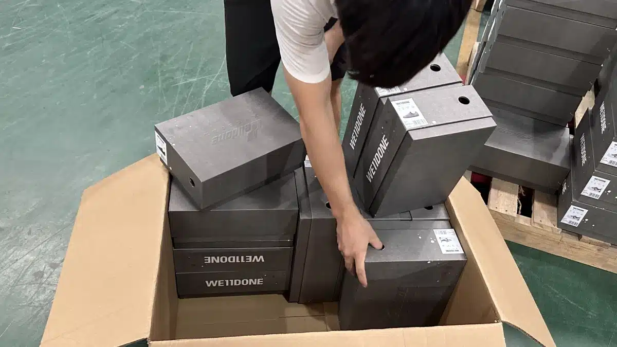 Warehouse worker preparing multiple ecommerce products for shipment to improve order accuracy, fulfillment performance, and long-term customer retention.