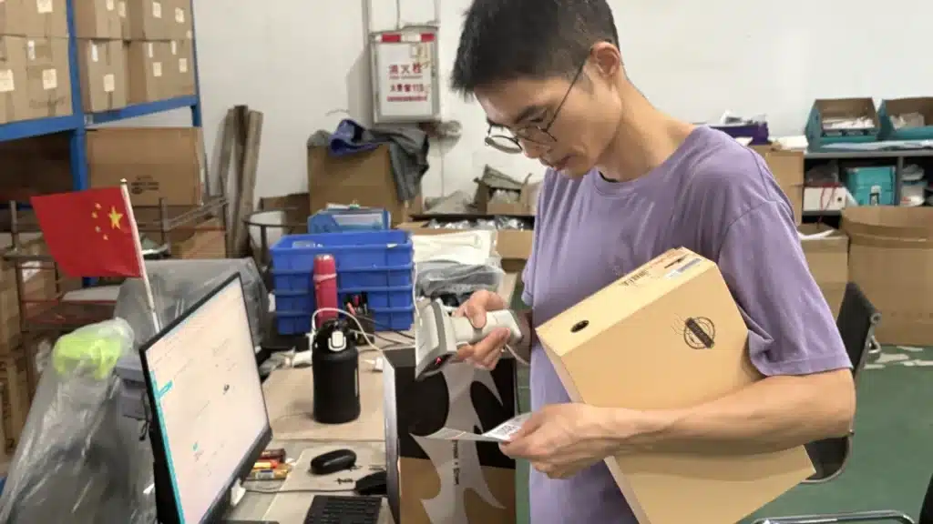 Warehouse worker scanning a shipping label during pick and pack fulfillment to improve order accuracy and inventory tracking for small businesses.
