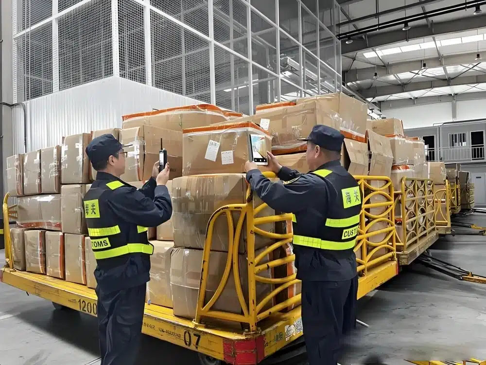 Customs officers documenting and inspecting held cargo at a customs clearance facility to resolve shipment delays