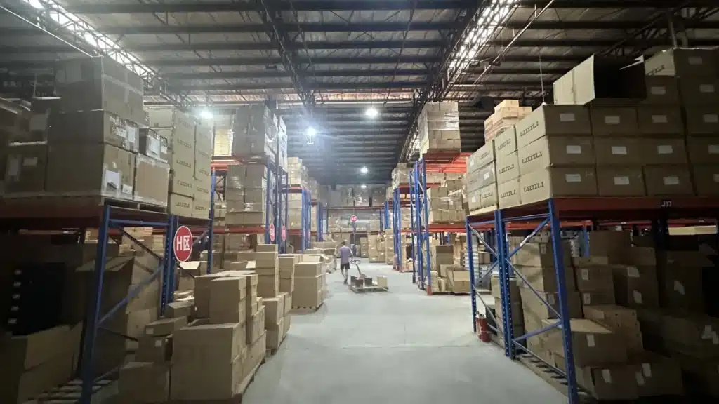 Large fulfillment warehouse with multiple inventory zones and storage racks, representing multi-location fulfillment, inventory diversification, and reduced geographic supply chain risk.