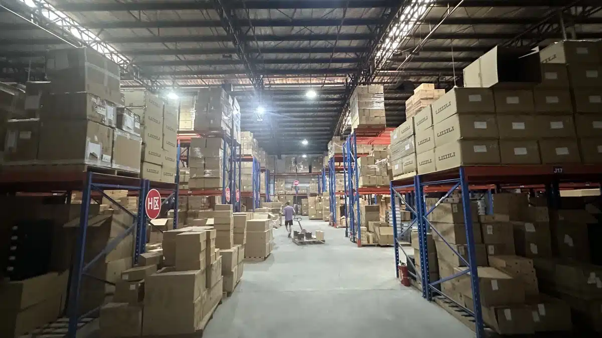 Large fulfillment warehouse with multiple inventory zones and storage racks, representing multi-location fulfillment, inventory diversification, and reduced geographic supply chain risk.