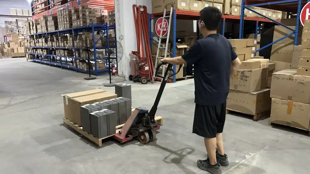 Warehouse worker moving ecommerce inventory on a pallet, illustrating fulfillment operations used to control fulfillment cost per order and improve logistics efficiency.