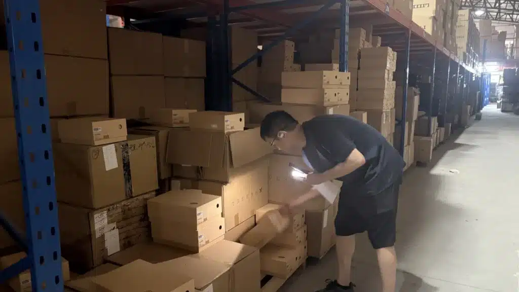 Warehouse worker packing ecommerce orders as part of an inventory planning strategy supported by demand forecasting and accurate stock management.